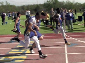Omaha North's Radell Nared breezes to victory in 100 meter while Kearney's Josh Mead (second from left works to edge out North's Thomas Hodges for second.